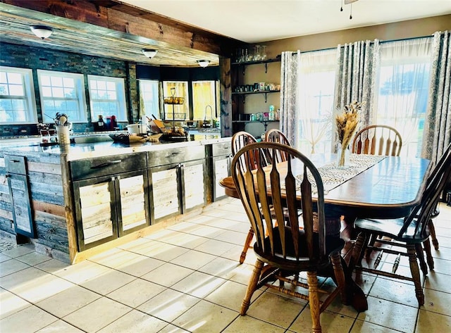 dining area featuring light tile patterned flooring and sink