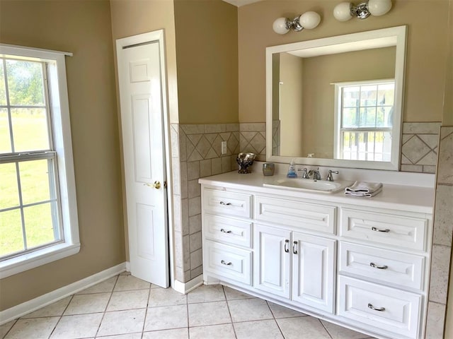 bathroom featuring tile patterned flooring, tile walls, and vanity