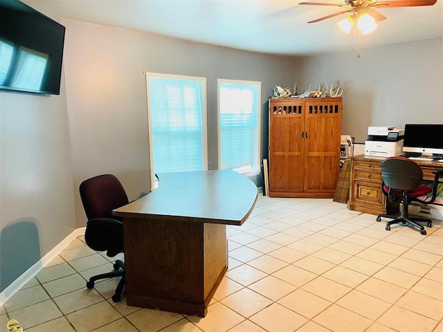 tiled home office featuring ceiling fan