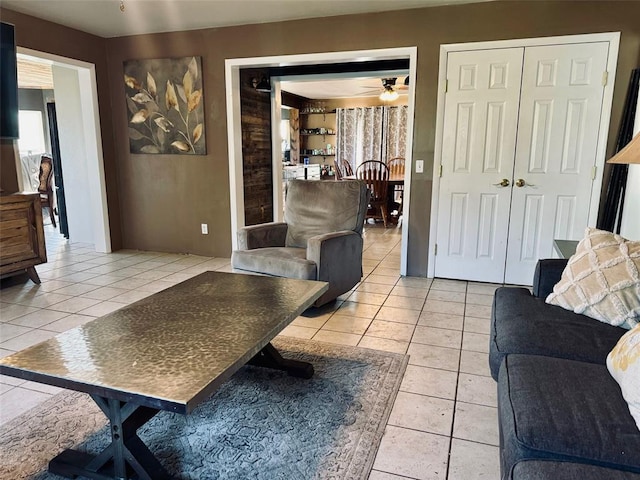 tiled living room with ceiling fan