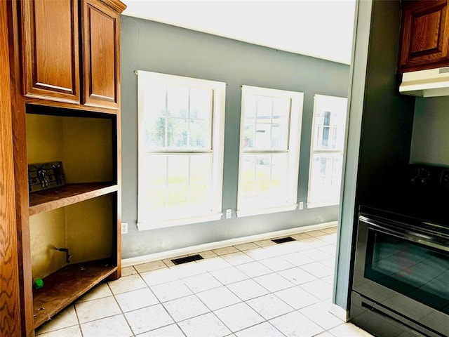 kitchen featuring light tile patterned flooring and range