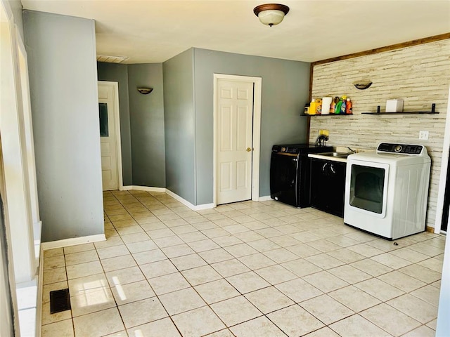 kitchen featuring light tile patterned floors, sink, and washer / clothes dryer