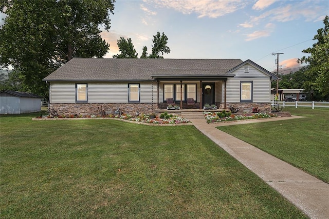 view of front facade featuring a yard and covered porch