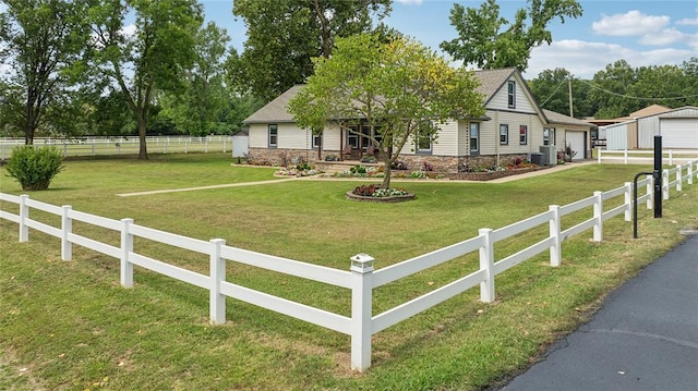 view of front of house featuring cooling unit, a front yard, and a garage