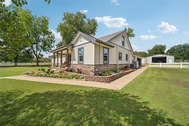 view of side of home featuring a yard and cooling unit