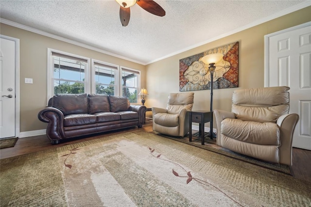 living room with hardwood / wood-style floors, a textured ceiling, ceiling fan, and crown molding