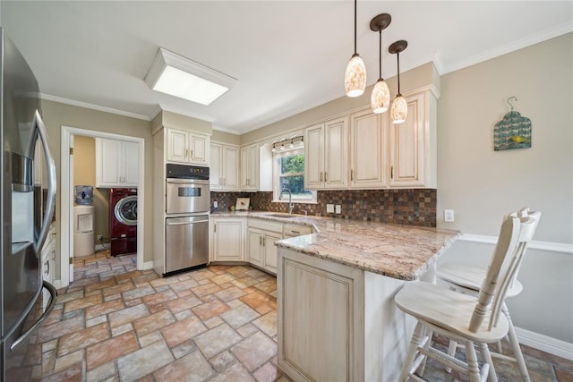 kitchen featuring a kitchen breakfast bar, decorative backsplash, light stone countertops, appliances with stainless steel finishes, and kitchen peninsula