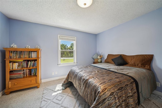 carpeted bedroom with a textured ceiling