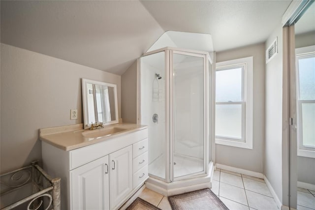 bathroom with tile patterned flooring, plenty of natural light, and vanity