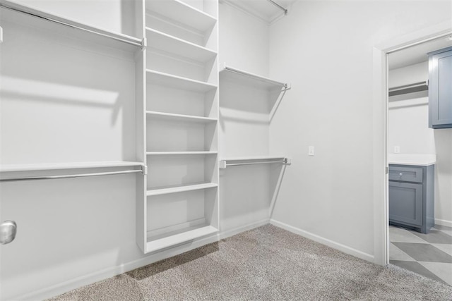 walk in closet featuring light carpet