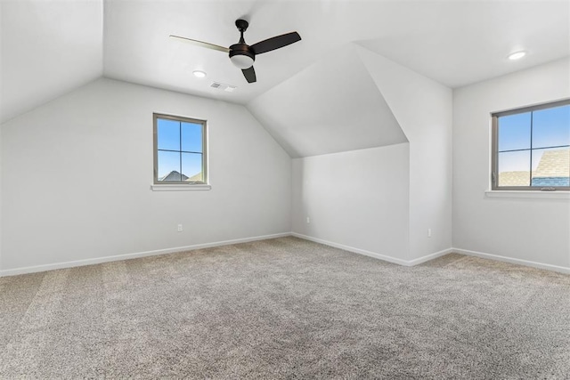 bonus room with plenty of natural light, ceiling fan, and carpet floors