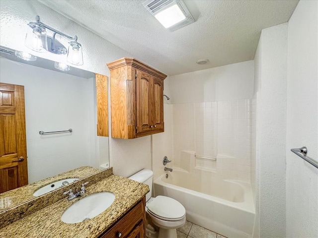 full bathroom featuring tile patterned floors, vanity, a textured ceiling, washtub / shower combination, and toilet