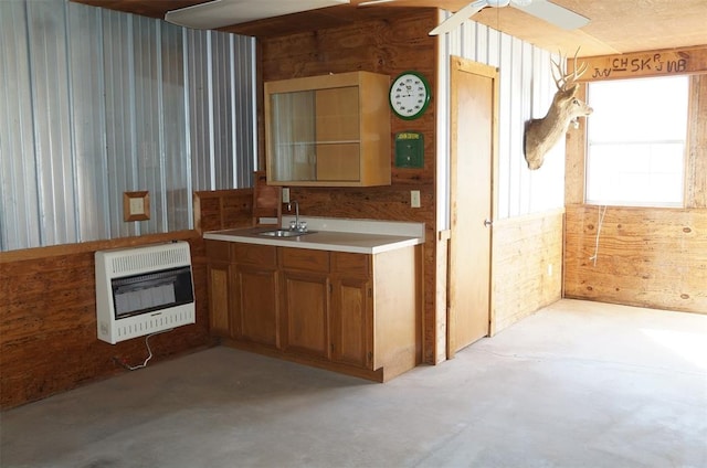 kitchen featuring heating unit, ceiling fan, and sink