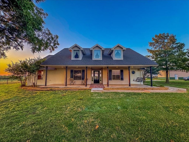 view of front of house featuring covered porch and a lawn