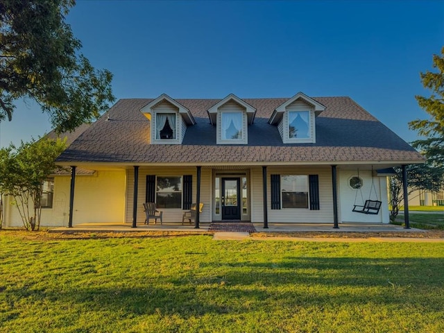 view of front of house featuring covered porch and a front lawn