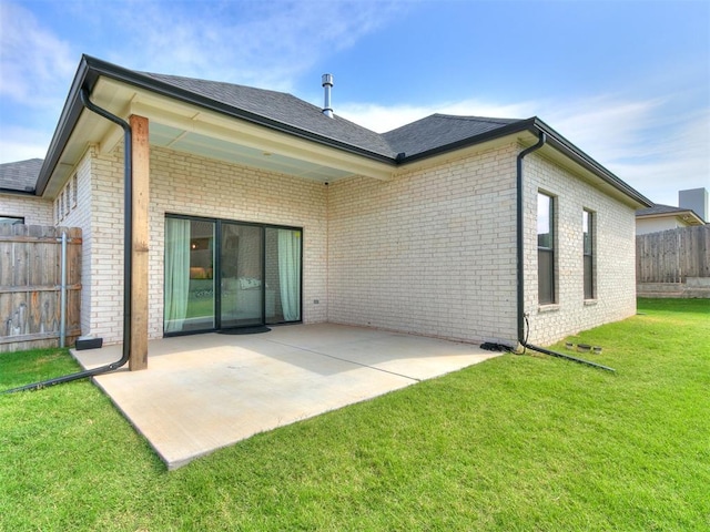 back of property featuring a lawn and a patio area