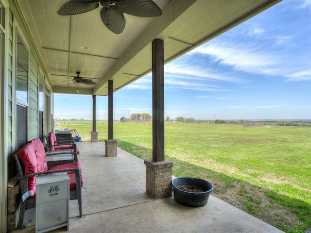 view of patio featuring outdoor lounge area, a rural view, and ceiling fan