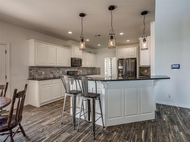 kitchen featuring dark hardwood / wood-style flooring, white cabinets, and stainless steel appliances