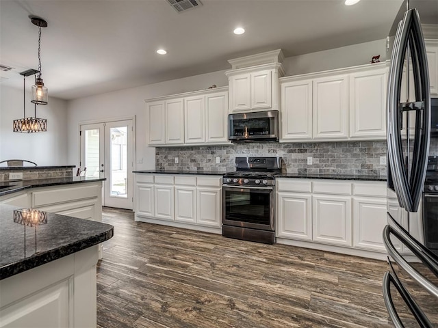 kitchen with dark hardwood / wood-style flooring, stainless steel appliances, and white cabinetry