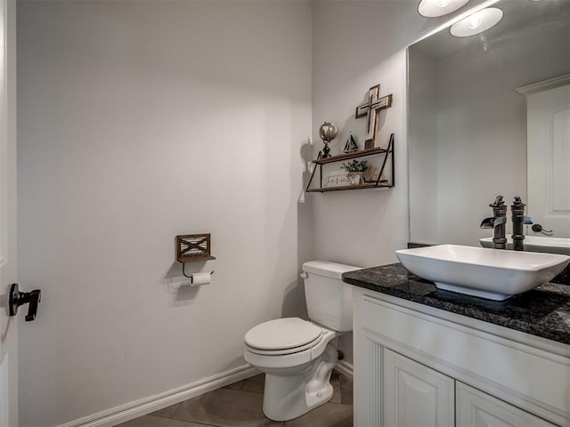 bathroom with tile patterned flooring, vanity, and toilet