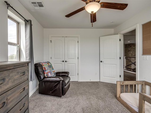 living area featuring ceiling fan and carpet