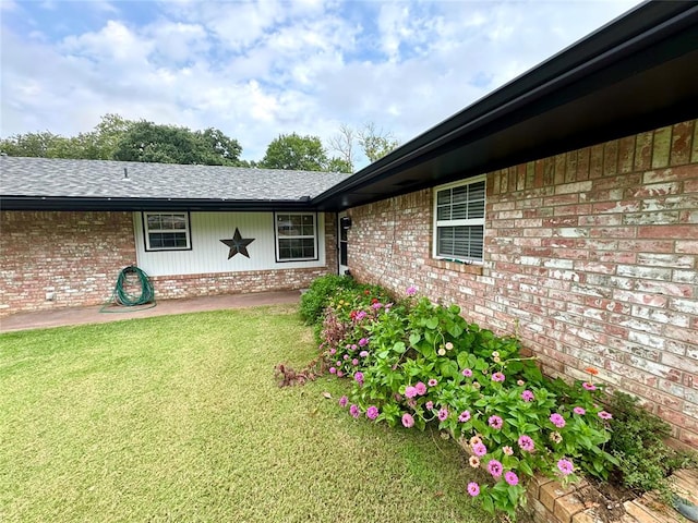 view of exterior entry with a lawn