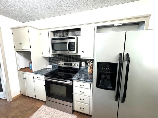 kitchen with tasteful backsplash, white cabinetry, a textured ceiling, and appliances with stainless steel finishes