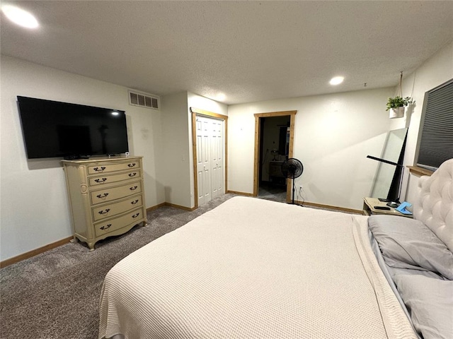 carpeted bedroom featuring a textured ceiling and a closet