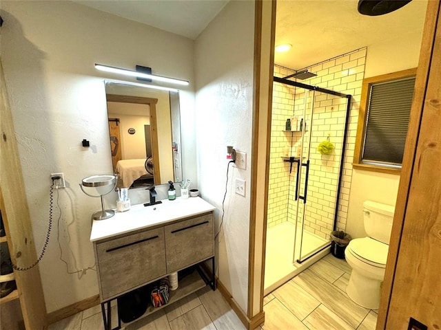 bathroom with vanity, toilet, and walk in shower