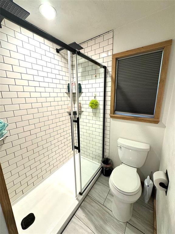 bathroom with toilet and walk in shower