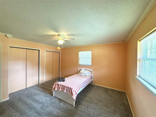 carpeted bedroom featuring ceiling fan, a textured ceiling, and multiple windows