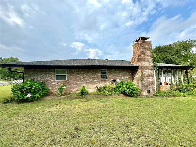 rear view of house featuring a lawn