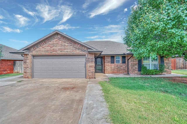 ranch-style house featuring a front yard and a garage