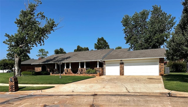 ranch-style home featuring a front yard and a garage