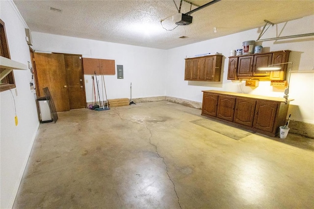 garage featuring electric panel and a garage door opener