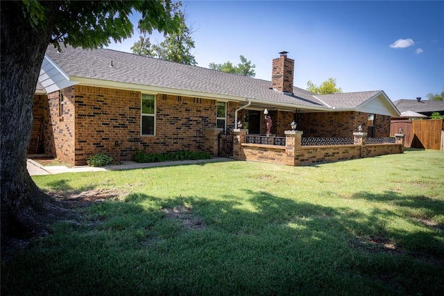 back of property featuring a lawn