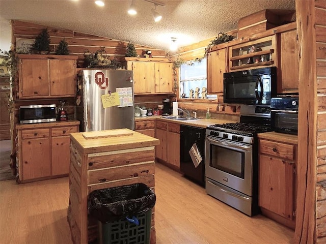33308 S Post Office Nck, Shawnee, OK 74801 - kitchen with black appliances, butcher block countertops, light wood-type flooring, a sink, and vaulted ceiling