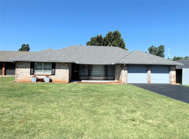 ranch-style home with a front yard and a garage