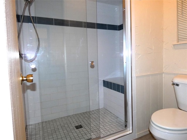 bathroom featuring an enclosed shower and toilet