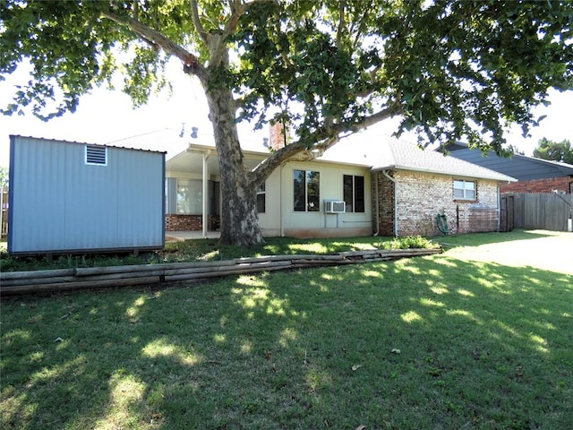 view of front of property with cooling unit and a front yard