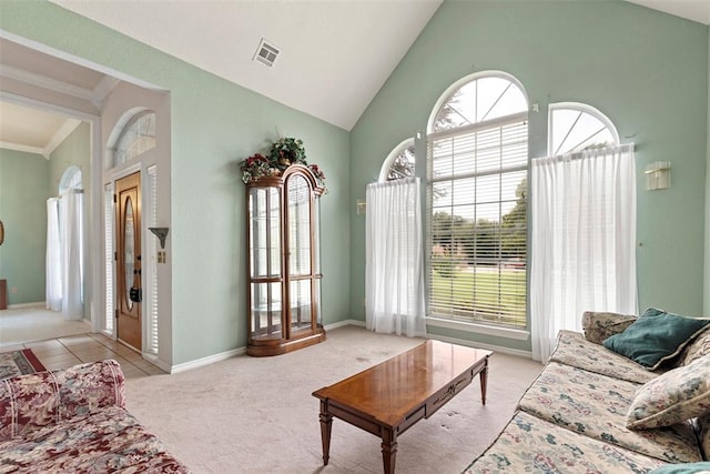 living room with light carpet, high vaulted ceiling, and ornamental molding