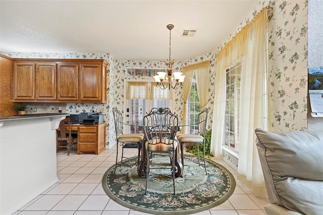 dining room with a chandelier and light tile patterned flooring