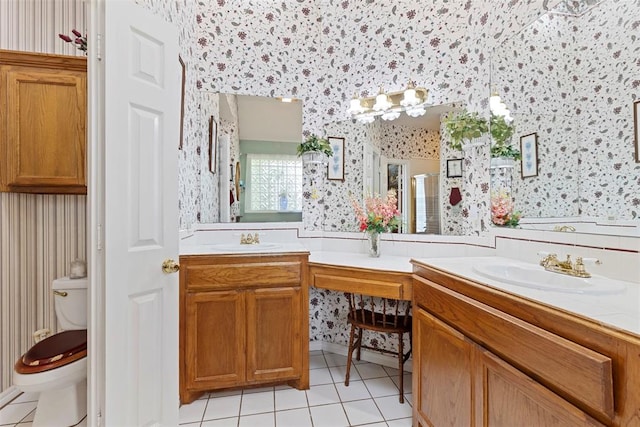 bathroom with tile patterned flooring, vanity, toilet, and a shower with door