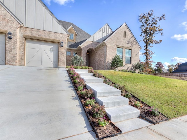 view of front of property featuring a garage and a front lawn