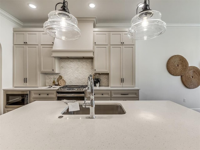 kitchen featuring decorative backsplash, gas range, black microwave, and pendant lighting