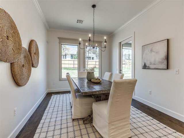 dining space with crown molding, dark wood-type flooring, and a notable chandelier