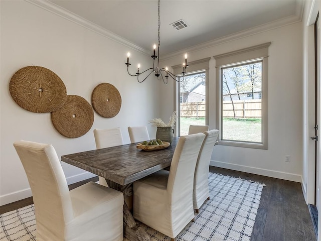 dining space with crown molding, dark hardwood / wood-style flooring, and a notable chandelier