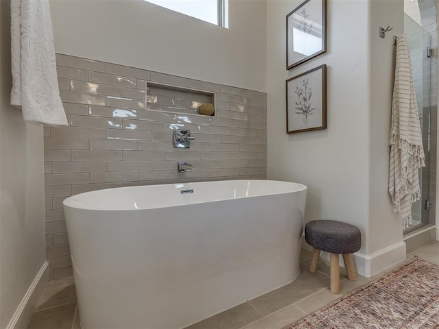 bathroom with tile patterned flooring and independent shower and bath