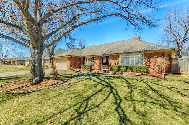 single story home with a garage and a front lawn