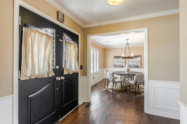 entryway with french doors, dark hardwood / wood-style floors, and ornamental molding